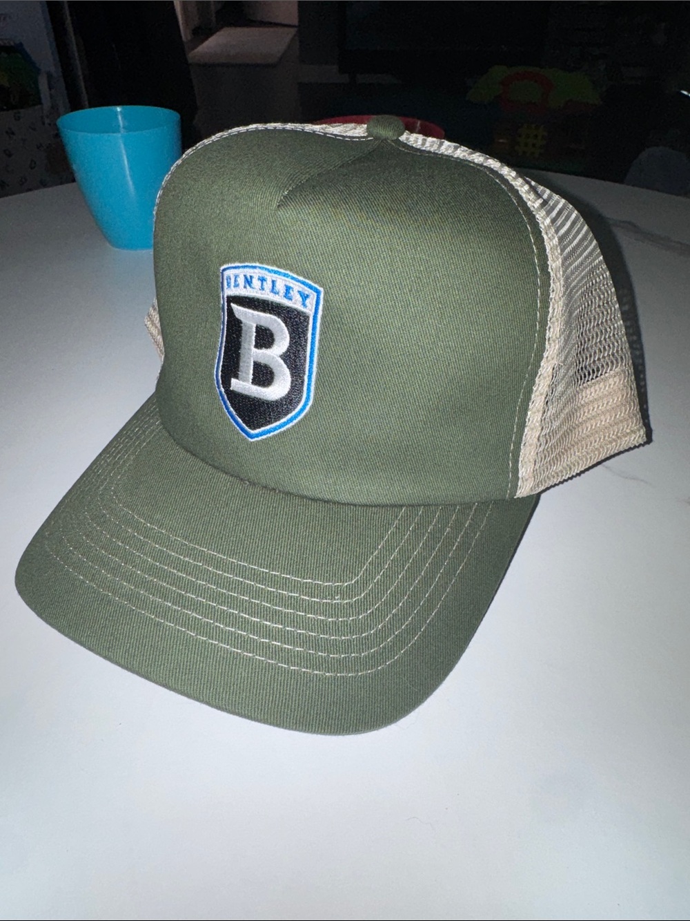 Olive green/khaki trucker hat with Bentley logo